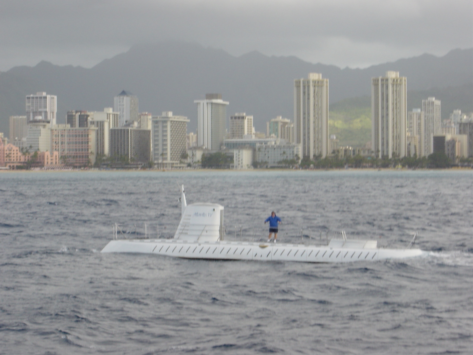 White Atlantis tourist submarine on the surface with the Waikiki skyline behind