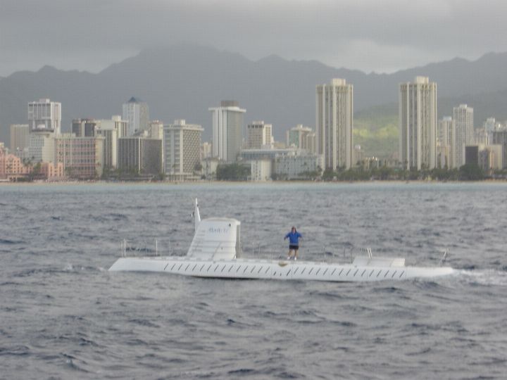White Atlantis tourist submarine on the surface with the Waikiki skyline behind